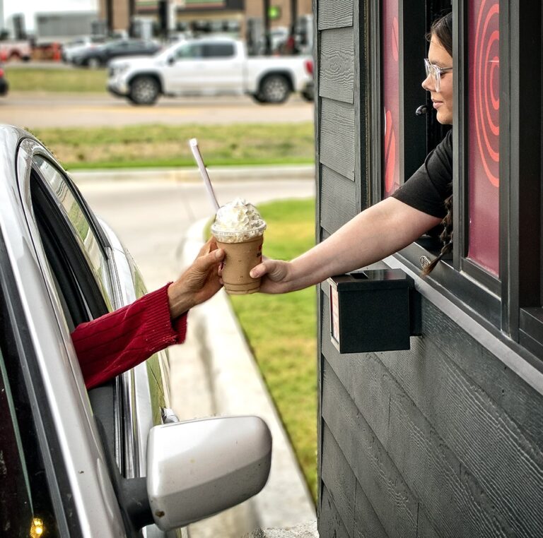 2023 Cassidy serves customer at Scooters816 WEB 768x762